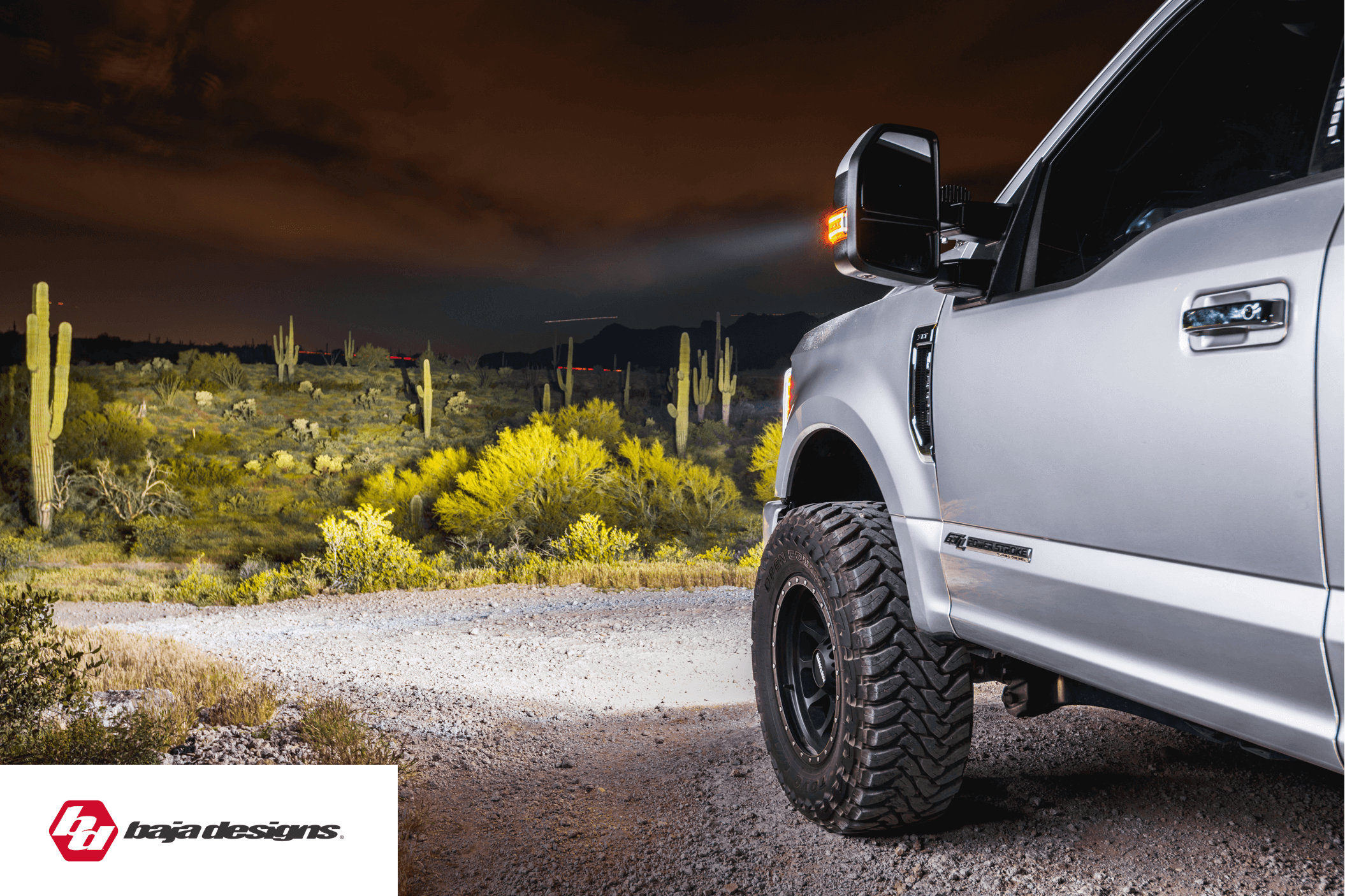 a white truck parked in a dirt road